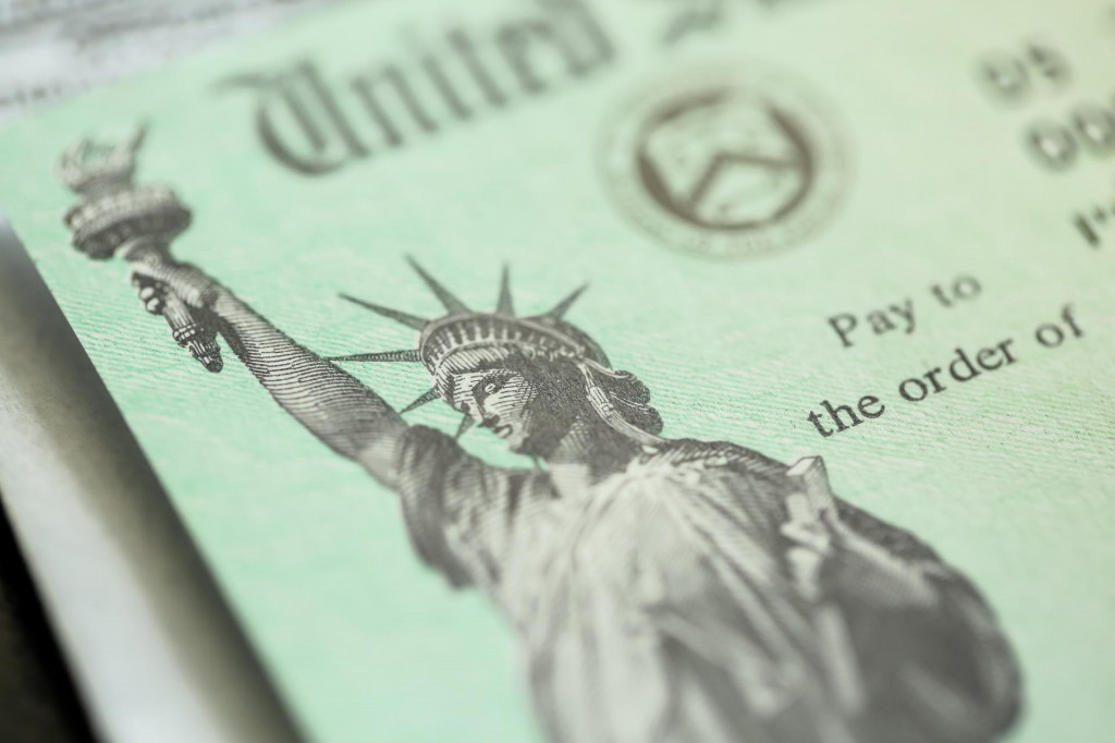 Extreme close-up of Federal coronavirus stimulus check provided to all Americans from the United States Treasury in 2020, showing the statue of liberty.