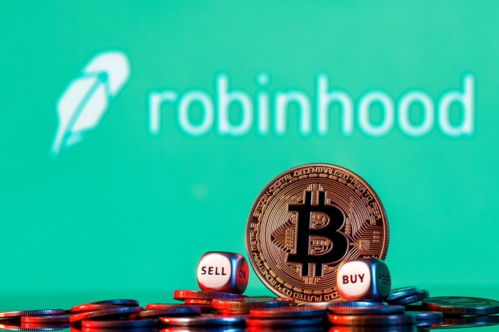 &lt;p&gt;Kazan, Russia - Oct 19, 2021Robinhood Markets is an American broker-dealer company. Golden bitcoin with two buy-sell cubes in a pile of coins on the background of the Robinhood logo.&lt;/p&gt;