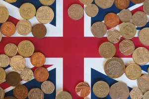 Pound coins money (GBP), currency of United Kingdom, over the Union Jack