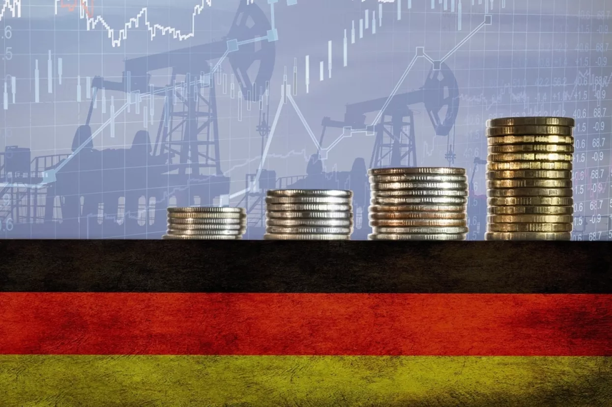 Coins on top of the flag of Germany on the background of oil rigs and charts. Concept - increase in the cost of gasoline, diesel, energy in Germany. Increase in the selling price of hydrocarbons.<br>njemačka, inflacija, rast cijena, troškovi, porast troškova, industrija, proizvodnja