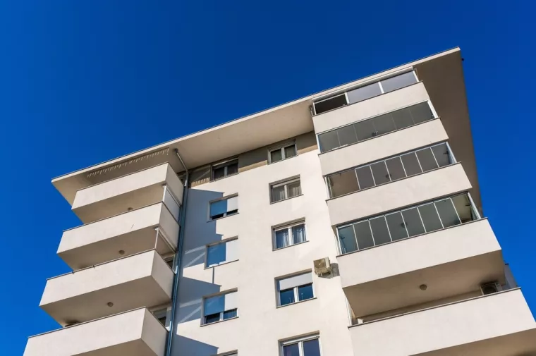 Zagreb, Croatia, October 20th, 2024A modern residential building featuring balconies with glass railings and a beige facade under a clear sky in Zagreb.Zagreb, stanovi. zgrada, zgrade, priuštivo stanovanje