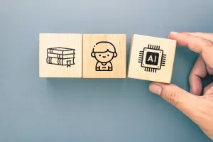 Wooden blocks showing books, student and AI chip icons, concept of modern education, digital learning, human knowledge and artificial intelligence in classrooms