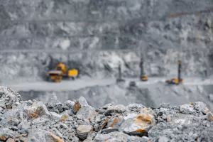 Industry open pit mine for extraction of gold, copper and iron using big yellow truck industrial machines.